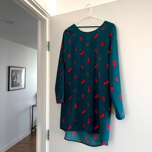 Teal and pink printed dress worn twice. Hits at midthigh with open back detail.